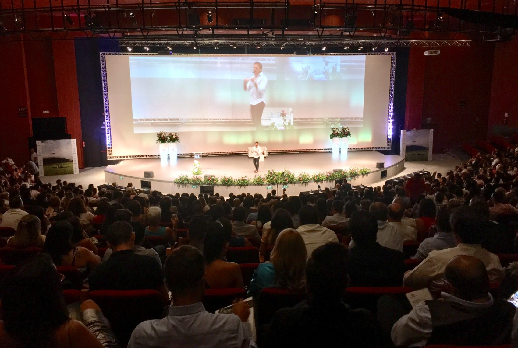 Joshua Ariel speaking to a packed auditorium